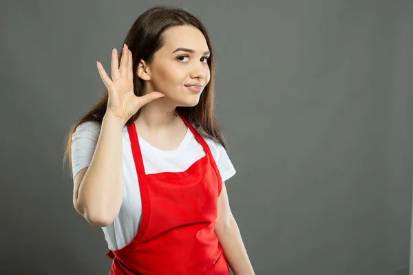 Portrait Young Female Supermarket Employee Making Can Hear Gesture Gray — Stock Photo, Image