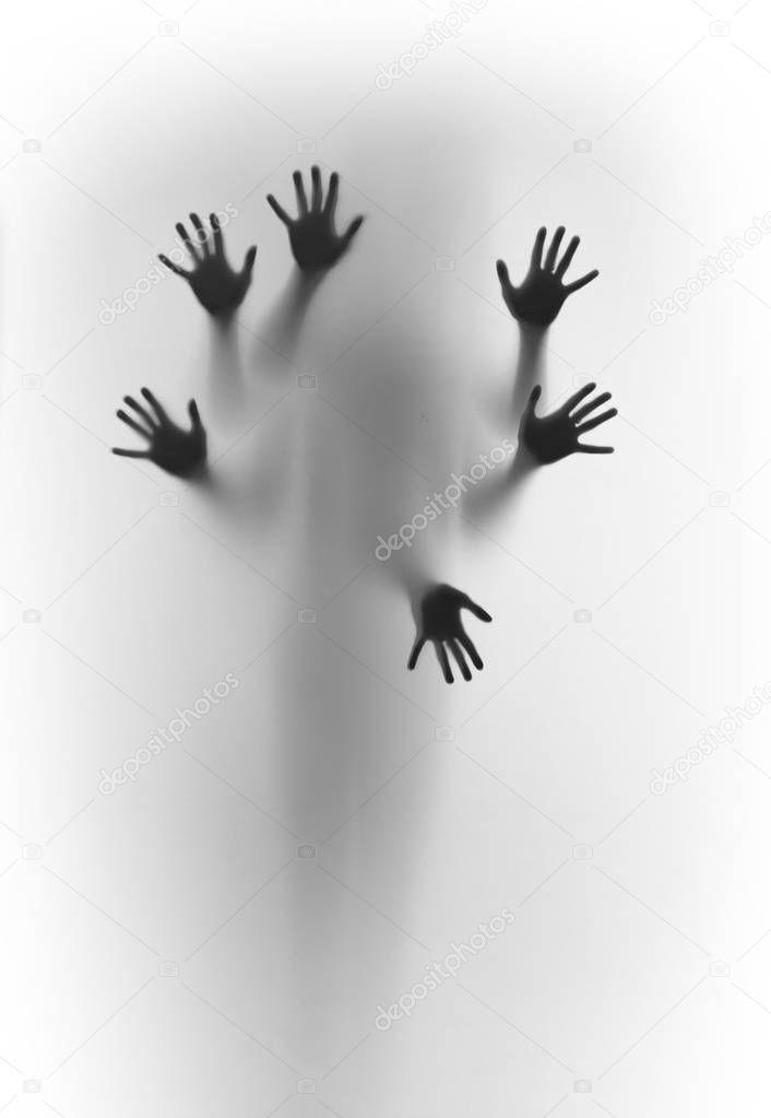 Blurred human body shape spirit stands behind diffuse surface, six hands can be seen sharply, fingers and palms.