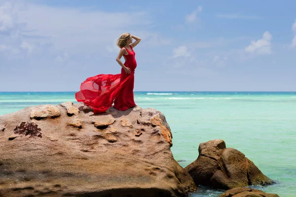 Beautiful Pregnant Woman Flying Long Red Dress Poses Huge Rock — Stock Photo, Image