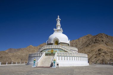 View of Tall Shanti stupa with beautiful blue sky, the big stupa in Leh and one from the best buddhist stupas in Jammu and Kashmir, Ladakh, India. White stupa in the Himalayan mountains clipart