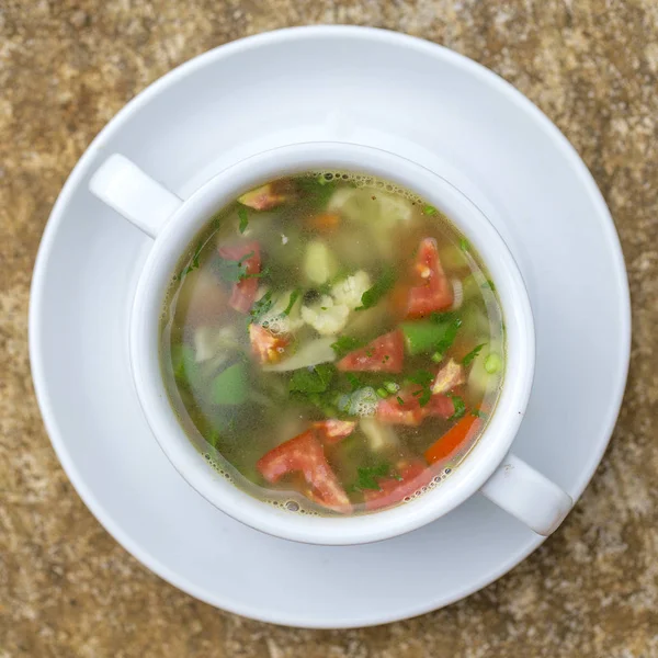 Vegetable soup with ingredients cauliflower, red tomato, green beans in white plate, top view, close up — Stock Image Vegetable Soup Ingredients Cauliflower Red Tomato Green Beans White Plate Stock Photo