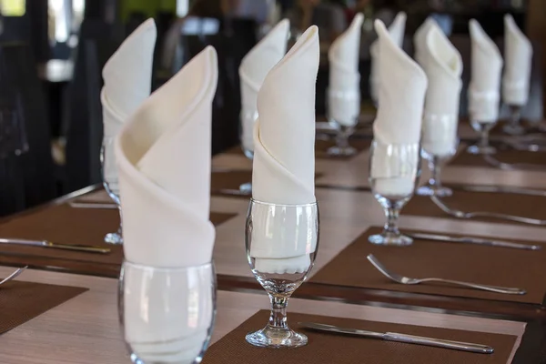 Glasses and napkin on table in restaurant - food background. Table arrangement in an expensive haute cuisine restaurant