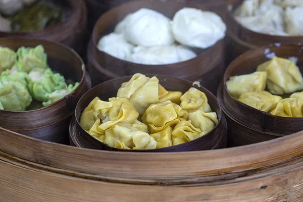 Fresh dim sum in bamboo steamer, chinese cuisine for sale at a local market in Ubud, Bali, Indonesia. Close up