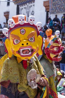 HEMIS, INDIA - JUNE 27, 2015 : Tibetan buddhist lamas dressed in mystical mask dance Tsam mystery in time of Hemis Tse Chu festival, Ladakh, North India clipart