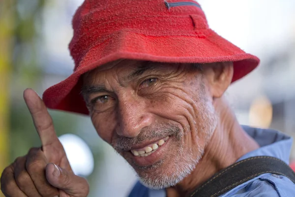 BANGKOK, THAILAND - NOVEMBER 03, 2017: Positive portrait of a thai man in street market, close up. Bangkok, Thailand