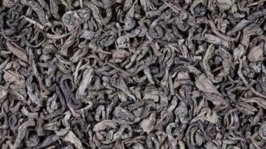 Arka plan yeşil çay yakın. Döngü döndürme. Kameranın ön kısmında plaka yeşil çay ile döner