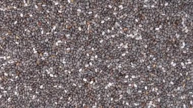 Chia tohum arka plan kazık, rotasyon loopable 4 k en iyi görünümü kapatın. Gıda arka plan. Gastronomi kavramı, organik gıda. Makro chia tohum 
