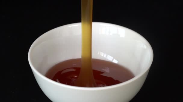 Pouring Honey White Bowl Close Honey Dripping Black Background Macro — Stock Video