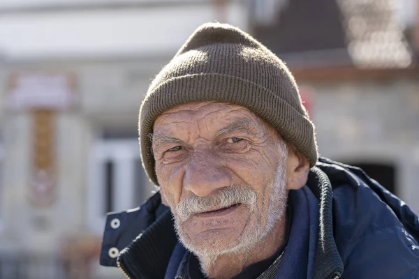 MTSKHETA, GEORGIA - OCTOBER 27, 2018 : Portrait of old man with a gray beard near old orthodox cathedral in historical town Mtskheta near Tbilisi, Georgia