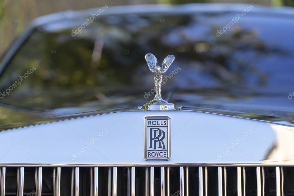 Close up of Rolls Royce logo on car
