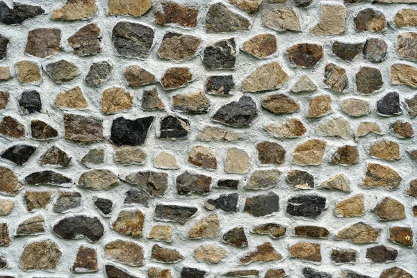 Background texture of stone wall, close up. Natural stone facade, wall tiles texture