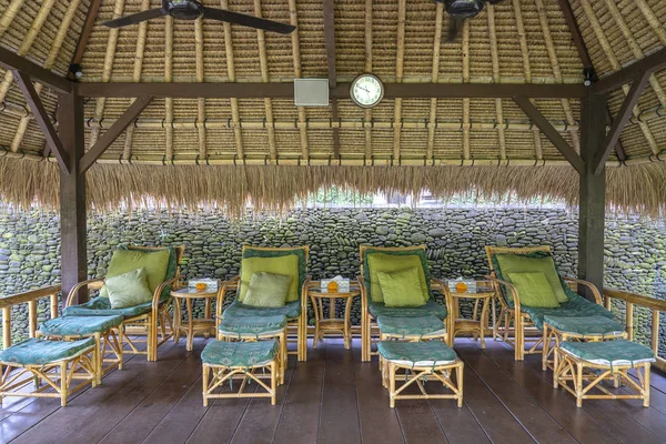 Massage table overlooking the tropical garden. Spa massage room with foot massage chairs on island Bali, Indonesia