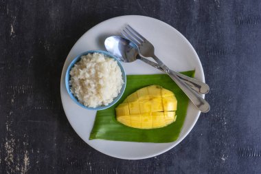 Tay tarzında tatlı, plaka üzerinde yapışkan pirinç ile mango. Sarı mango ve yapışkan pirinç olduğunu Tayland popüler geleneksel tatlı