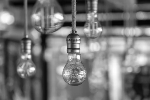 Decorative antique edison style light bulbs, vintage electric lamp, closeup. Black and white
