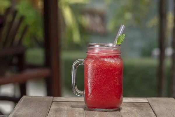 Fresh organic watermelon smoothie in glass mug on table, close up — Stock Photo, Image