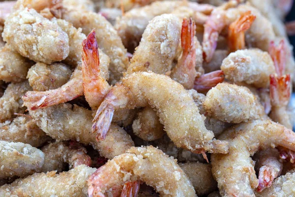 Fried shrimp deep-fried is a street food in local market in Thailand, closeup. Thai food