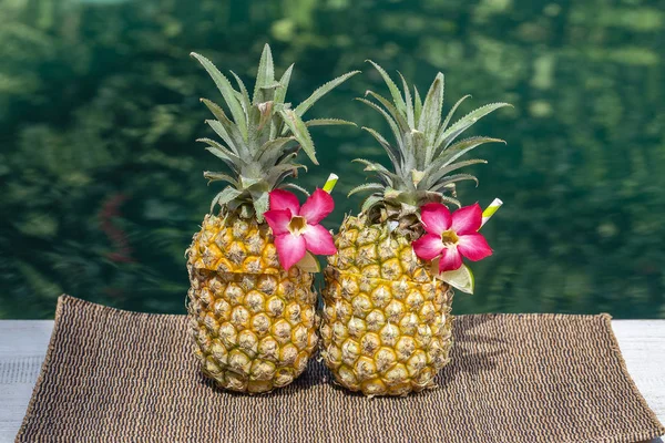 Pina colada cocktail in fresh pineapples near swimming pool, close up. Island Bali, Indonesia — Stock Photo, Image