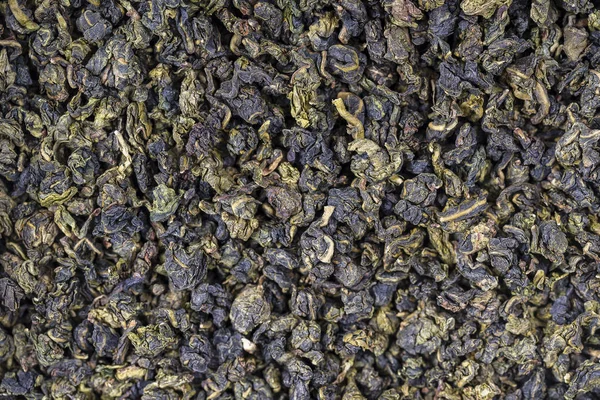 El té verde deja el fondo. Texturas de alimentos abstractos. De cerca. — Foto de Stock