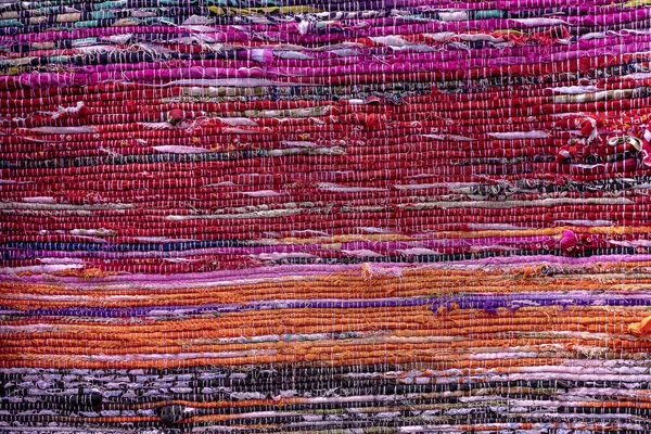 Cloth, typically produced by weaving or knitting textile fibers. Background and texture red old fabric. Closeup — Stock Photo, Image