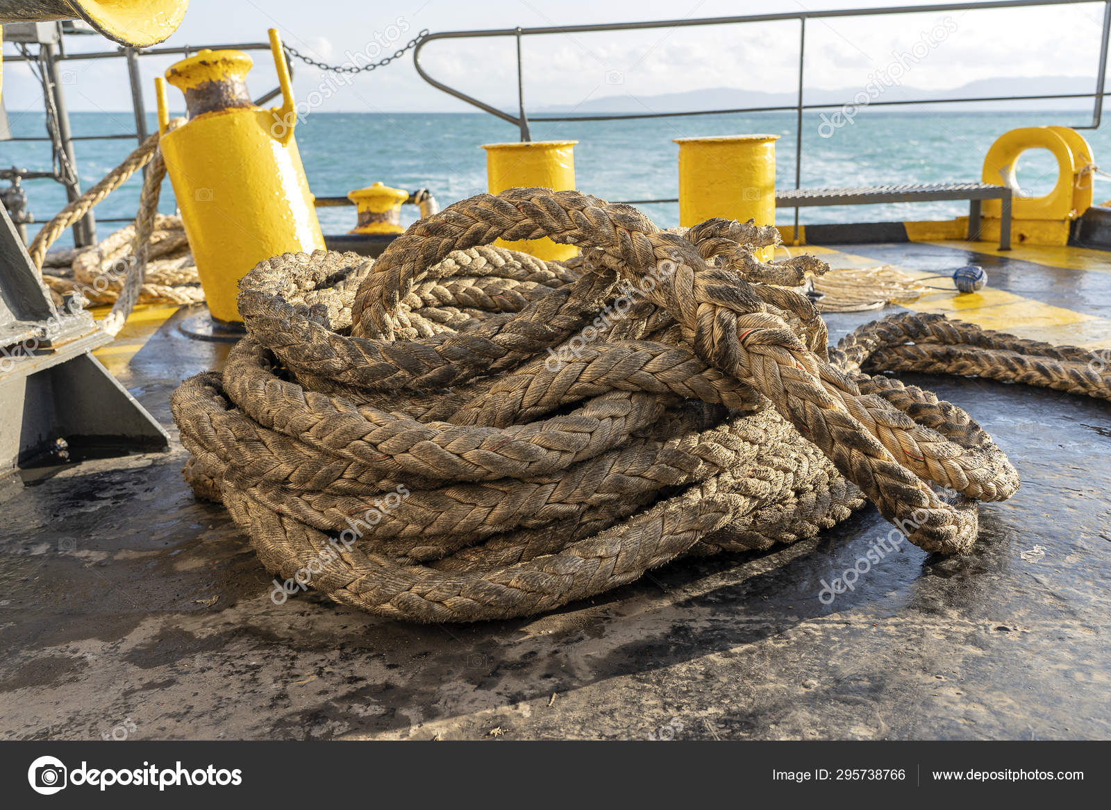 The deck of the ferry boat along with the a thick mooring rope and