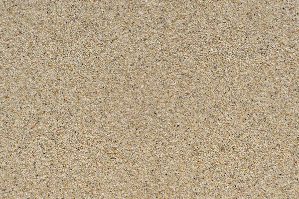 Zandstrand achtergrond. gedetailleerde zand textuur. bovenaanzicht — Stockfoto