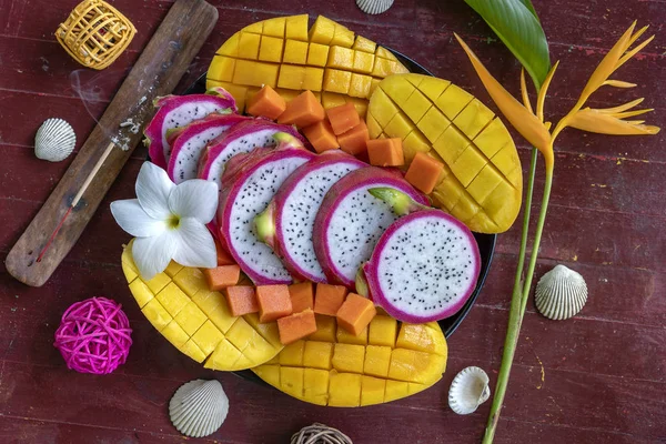 Tropical fruits assortment on a plate, close up