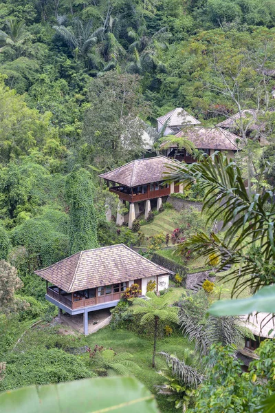 Balinese houses with view at tropical rain forest and mountain, Bali, Indonesia