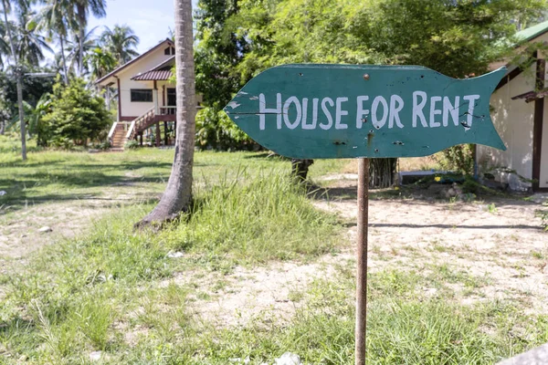 House for rent real estate sign in front of tropical house in island Koh Phangan, Thailand. Houses offered for rent to tourists.