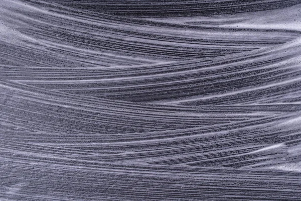 Abstrakcyjna tekstura pianki na czarnym tle. Mydło pianki pęcherzyki streszczenie ciemne tło — Zdjęcie stockowe