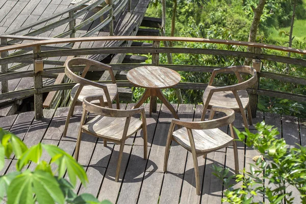 Wooden table and chairs in empty tropical cafe next to rice terraces in island Bali, Indonesia — Stock Photo, Image