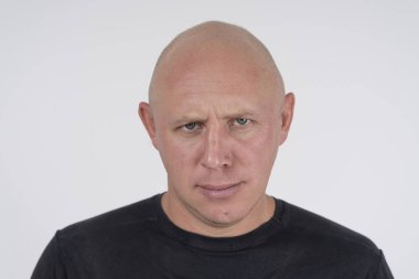 Portrait of an aggressive bald man, close up clipart