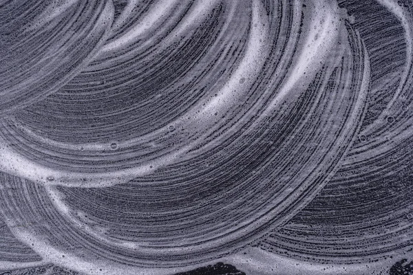 Textura de espuma abstracta sobre fondo negro. Jabón burbujas de espuma fondo oscuro abstracto —  Fotos de Stock