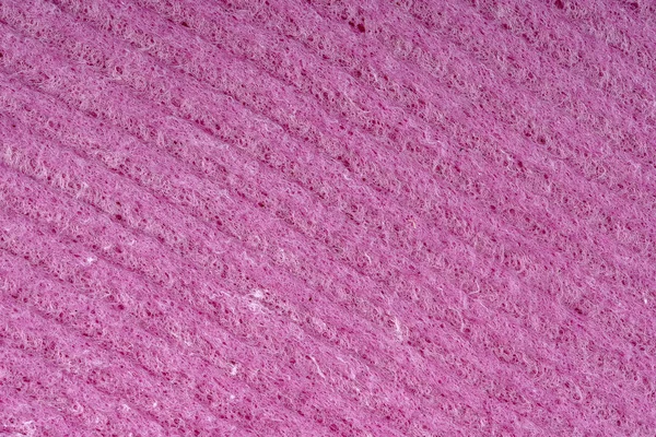 As esponjas de limpeza de casa fecham-se. Textura de detalhe esponja, textura de esponja close up fundo. Textura de esponja vermelha de celulose. Malha de arame rosa no fundo da superfície da esponja — Fotografia de Stock