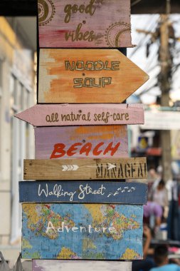 Wooden signs on street in island Koh Phangan, Thailand. Close up clipart
