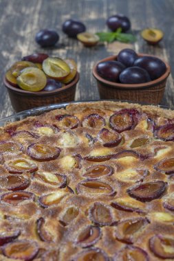 Ev yapımı organik erik lişeyli tatlı yemeye hazır, yakından. Eski ahşap arka plan üzerinde Erik tart, yakın