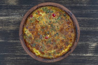 Sebze frittata, basit vejetaryen gıda ile Seramik kase. Ahşap masa üzerinde domates, biber, soğan ve peynir ile Frittata, yakın. İtalyan yumurtalı omlet