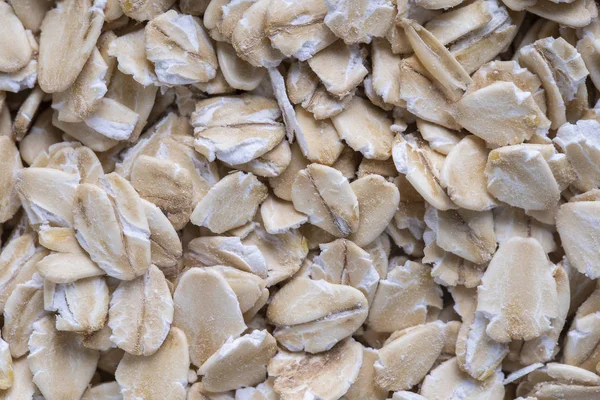 Golden cereal muesli, background and texture. Oatmeal grains closeup, top view, macro. Healthy breakfast — Stock Photo, Image