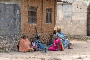 Zanzibar, Tanzanya - 16 Kasım 2019: Afrikalı kadın ve çocuklar Zanzibar Adası, Tanzanya, Doğu Afrika yakınlarındaki sokakta oturuyorlar