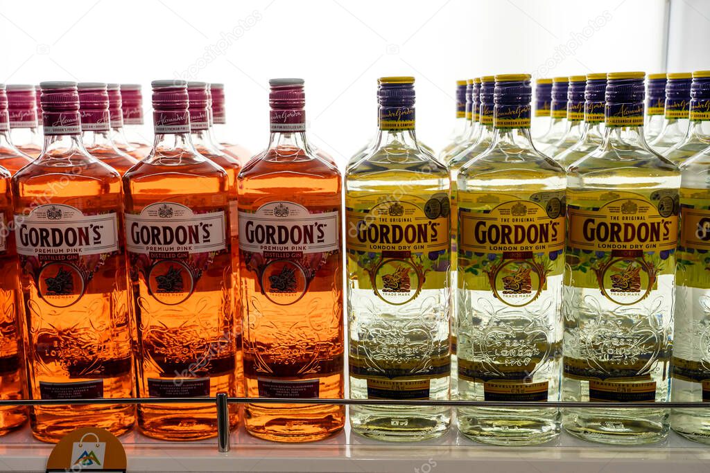 Muscat, Oman - january 19, 2020 : Bottles of Gordon's London Dry Gin and Premium Pink Gin on a shelf in duty free shop airport in Muscat, Oman