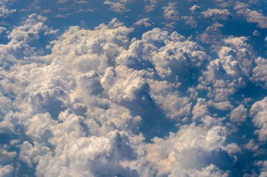Beyaz bulutlar ve gökyüzü, uçak penceresinden bir manzara. Doğa arkaplanı