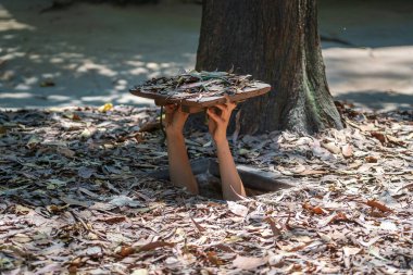 Tourist at the entrance of Cu Chi Tunnels in Ho Chi Minh, Vietnam, close up clipart