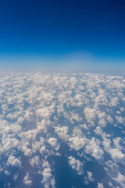 White clouds and blue sky, a view from airplane window. Nature background