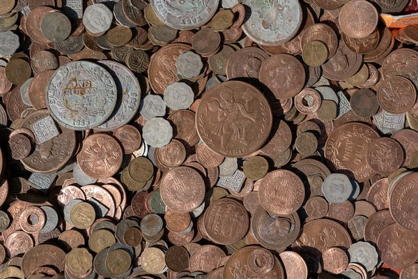 Old vintage fake coins background for sale to tourists in the Indian market on the street in Rishikesh, India. Close up, top view