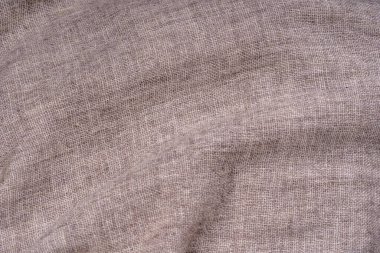 Arka plan olarak buruşmuş tekstil dokusu. Tasarım için doğal kumaş dokusu. Kapat.