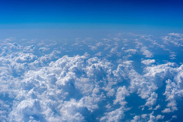 White clouds and blue sky, a view from airplane window. Nature background