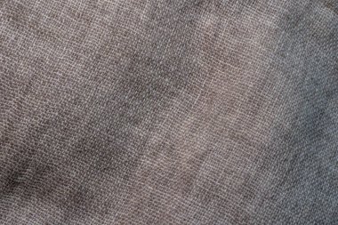 Arka plan olarak buruşmuş tekstil dokusu. Tasarım için doğal kumaş dokusu. Kapat.