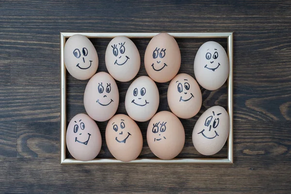 Picture Golden Frame Many Funny Eggs Smiling Dark Wooden Wall — Stock Photo, Image