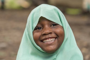 Zanzibar, Tanzanya - 30 Ekim 2019: Tanzanya, Doğu Afrika 'daki Zanzibar adasında dersten sonra yerel bir okulun yakınlarında kimliği belirsiz Afrikalı kız
