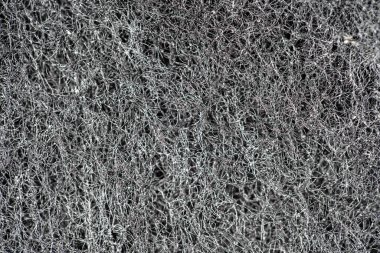 Karanlık soyut arka plan ve birbirine geçmiş saç telleri, lifler ve nanofiberler. Sünger detay dokusu, sünger dokusu arkaplanı kapat. Selüloz sünger dokusu. Siyah ve beyaz