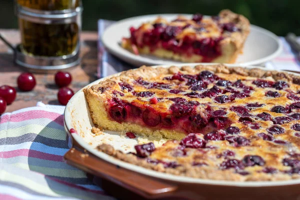 Ev yapımı vişneli turta. Bahçedeki ahşap masada. Kırsal arka planda.